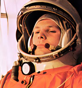 Astronaut in an orange spacesuit and helmet